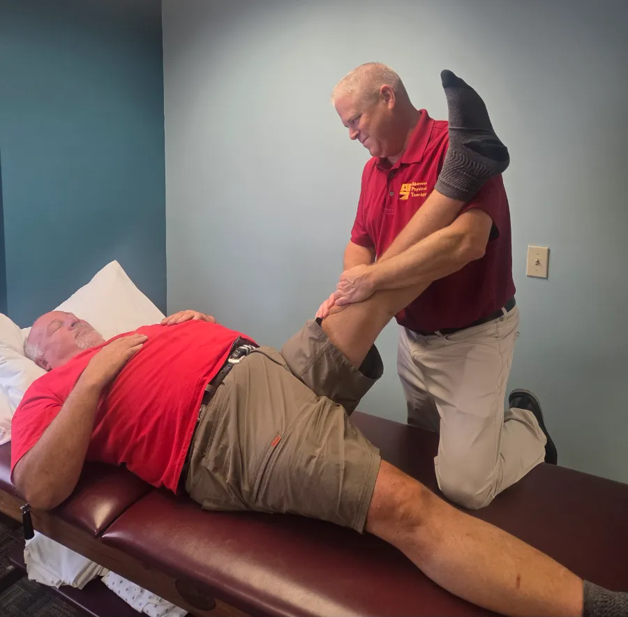 physical therapist stretching his patient's leg for physical therapy at Albanese Physical Therapy