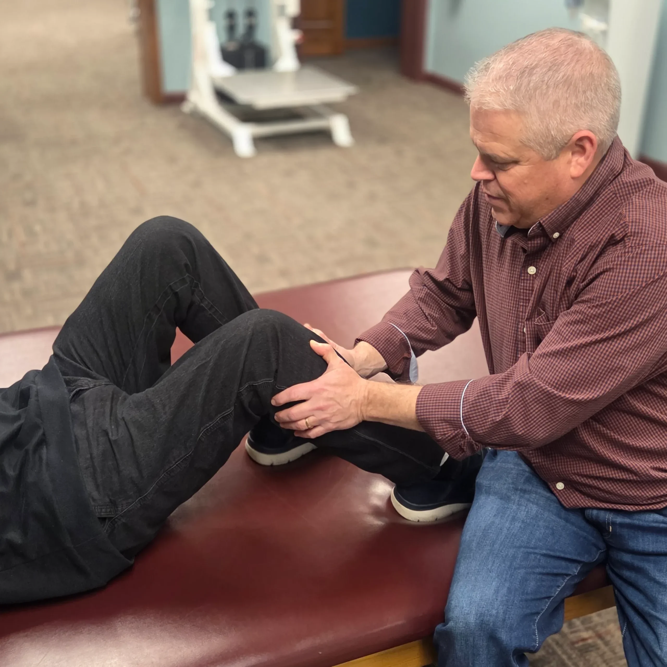 physical therapist using physical therapy techniques on patient's knee at Albanese Physical Therapy